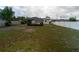 Large backyard with metal carport, shed, and white vinyl fence surrounding property at 2610 E Yukon St, Tampa, FL 33604