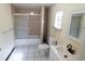 Bathroom with shower and tub combination, window, and vanity at 2610 E Yukon St, Tampa, FL 33604