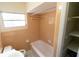 Bathroom featuring a shower-tub and window for natural light at 2610 E Yukon St, Tampa, FL 33604