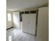 Bedroom showcasing bright, tiled floors, storage and exterior access at 2610 E Yukon St, Tampa, FL 33604