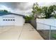 Spacious driveway leads to an attached garage, complemented by fenced perimeters on both sides at 2610 E Yukon St, Tampa, FL 33604