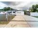 Charming single-story home boasts a freshly painted exterior, an attached garage, and a well-maintained front yard at 2610 E Yukon St, Tampa, FL 33604