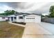 Charming single-story home boasts a freshly painted exterior, an attached garage, and a well-maintained front yard at 2610 E Yukon St, Tampa, FL 33604