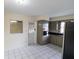 Spacious kitchen featuring stainless appliances, tile flooring, and natural light at 2610 E Yukon St, Tampa, FL 33604