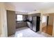 This kitchen features tile flooring, stainless steel refrigerator, and painted cabinets at 2610 E Yukon St, Tampa, FL 33604