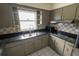View of the kitchen showcasing the countertops, cabinetry, backsplash, and appliances at 2610 E Yukon St, Tampa, FL 33604