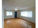 Cozy living room features wood floors, a ceiling fan, and large windows at 2610 E Yukon St, Tampa, FL 33604