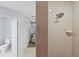 Bathroom featuring a separate toilet area, tile flooring, and a walk-in shower with neutral tile surround at 26290 Hayman Rd, Brooksville, FL 34602