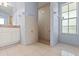 Bathroom featuring a double sink vanity, tile flooring, neutral paint, and a walk-in shower with tile surround at 26290 Hayman Rd, Brooksville, FL 34602