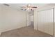 Bedroom featuring plush carpet, ceiling fan, closet, and neutral walls at 26290 Hayman Rd, Brooksville, FL 34602