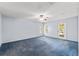 Bright, spacious bedroom with carpet flooring, ceiling fan and glass doors to the exterior at 26290 Hayman Rd, Brooksville, FL 34602