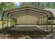 The metal carport features a concrete floor, covering for two cars, and a garage at 26290 Hayman Rd, Brooksville, FL 34602