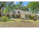 Charming single-story home with a well-maintained lawn and mature trees offering shade and curb appeal at 26290 Hayman Rd, Brooksville, FL 34602