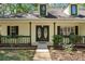 Inviting front entrance with decorative double doors, complemented by lush landscaping and a stone walkway at 26290 Hayman Rd, Brooksville, FL 34602