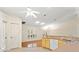 Bright kitchen area showing bar, cabinets, flooring and view to the formal entry at 26290 Hayman Rd, Brooksville, FL 34602