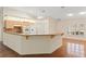 Open kitchen and dining area with a breakfast bar and natural lighting at 26290 Hayman Rd, Brooksville, FL 34602