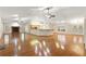 Spacious living room featuring hardwood floors, high ceilings, fireplace, and open to the kitchen at 26290 Hayman Rd, Brooksville, FL 34602