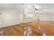 Open living area featuring hardwood floors, high ceilings, and access to a kitchen at 26290 Hayman Rd, Brooksville, FL 34602
