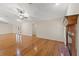Bright living room featuring hardwood floors, a brick fireplace, and French doors leading outside at 26290 Hayman Rd, Brooksville, FL 34602