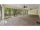 A very large screened in patio with brick floors, high ceilings, and beautiful views of the yard at 26290 Hayman Rd, Brooksville, FL 34602