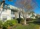 Exterior view of Tiffany Gardens showcasing the building facade, landscaping, and well-maintained grounds at 3100 Hartford N St # 221, St Petersburg, FL 33713
