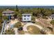 Aerial view of home with lush landscaping, bay access, and circular driveway at 3457 Cyclone Dr, Weeki Wachee, FL 34607