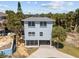 Aerial view of exterior elevation with circular drive and covered patio at 3457 Cyclone Dr, Weeki Wachee, FL 34607