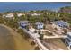 Expansive aerial shot showcasing a waterfront property with multiple homes surrounded by greenery and water views at 3457 Cyclone Dr, Weeki Wachee, FL 34607