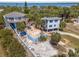 Stunning aerial view of waterfront property with lush landscaping and charming blue stilt houses at 3457 Cyclone Dr, Weeki Wachee, FL 34607