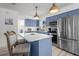 Modern kitchen features blue cabinets, stainless appliances, and a marble-topped island at 3457 Cyclone Dr, Weeki Wachee, FL 34607