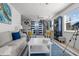 Spacious living area with stylish nautical decor, spiral staircase, and natural light at 3457 Cyclone Dr, Weeki Wachee, FL 34607
