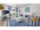 Living area with cozy seating, nautical décor, and access to an outdoor balcony at 3457 Cyclone Dr, Weeki Wachee, FL 34607