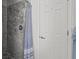 Modern shower with marbled walls and a glass enclosure adjacent to a white door at 3457 Cyclone Dr, Weeki Wachee, FL 34607