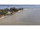 Scenic waterfront shot of a coastal property with a colorful home and expansive views of the calm water at 3457 Cyclone Dr, Weeki Wachee, FL 34607