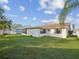 Large backyard with lush green grass, offering plenty of space for outdoor activities at 3646 Springfield Dr, Holiday, FL 34691