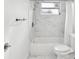 Bathroom featuring a marble-look shower over tub, rainfall showerhead at 3646 Springfield Dr, Holiday, FL 34691
