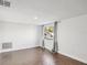 Bedroom with wood-look flooring, neutral walls, and a bright window at 3646 Springfield Dr, Holiday, FL 34691