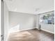 Bright bedroom with wood-look tile floors and lots of natural light at 3646 Springfield Dr, Holiday, FL 34691