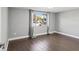Bedroom featuring wood-look flooring, neutral walls, and a bright window at 3646 Springfield Dr, Holiday, FL 34691