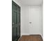 Hallway with closet and wood-look flooring, providing easy access to other rooms at 3646 Springfield Dr, Holiday, FL 34691