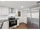 Modern kitchen featuring stainless steel appliances and white cabinets at 3646 Springfield Dr, Holiday, FL 34691