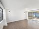 Sunlit living room features modern lighting, white brick accent wall, and sliding glass doors leading to the outdoors at 3646 Springfield Dr, Holiday, FL 34691