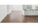 Bright living room featuring wood-look tile floors and a white brick accent wall, seamlessly blending style and comfort at 3646 Springfield Dr, Holiday, FL 34691