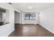 Inviting living room showcasing wood-look floors, neutral paint, and natural light at 3646 Springfield Dr, Holiday, FL 34691