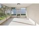 Bright sunroom with tile flooring and screened windows, perfect for enjoying natural light and outdoor views at 3646 Springfield Dr, Holiday, FL 34691