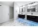 Stylish bathroom features dual vanities, marble-like tile flooring, and modern lighting at 3755 10Th S Ave, St Petersburg, FL 33711