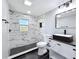 Updated bathroom featuring a marble-tiled shower, a modern vanity, and black hardware at 3755 10Th S Ave, St Petersburg, FL 33711