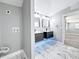 Stylish bathroom boasting dual vanities, chic lighting, and elegant marble tile flooring at 3755 10Th S Ave, St Petersburg, FL 33711