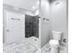 Refined bathroom with a tiled shower, modern fixtures, and beautiful marble-look flooring at 3755 10Th S Ave, St Petersburg, FL 33711