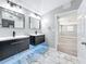 Modern bathroom featuring dual vanities, sleek fixtures, and marble tile flooring at 3755 10Th S Ave, St Petersburg, FL 33711